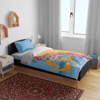 Bedding set on bed: blue pillowcases and orange-blue duvet with dove, dolphins, and flowers