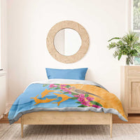 Bedding set with blue pillowcase and orange-blue duvet, dove, dolphins, and pink blossoms