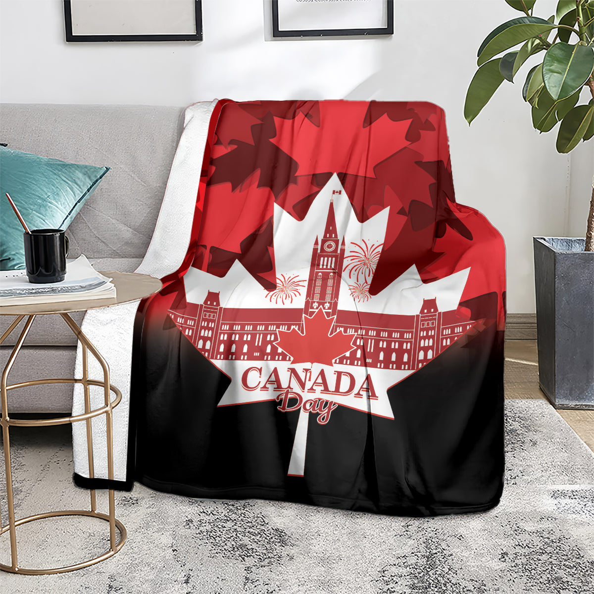 Canada Day blanket on a gray couch in red and black, maple leaf pattern and white skyline