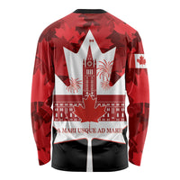 Red long-sleeve back shirt with maple leaf pattern, Canadian emblem, and slogan