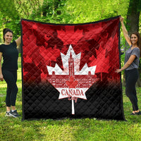 Quilt blanket showing white maple-leaf city and Canada Day text over red/black panels.