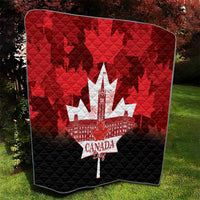 Red and black Canada Day quilt blanket with white maple-leaf city graphic and quilted pattern.