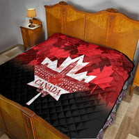 Red and black Canada Day quilt on bed with white maple-leaf city and quilted texture.