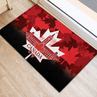 Red rubber doormat with Canada Day text, white monuments, and maple leaf shapes