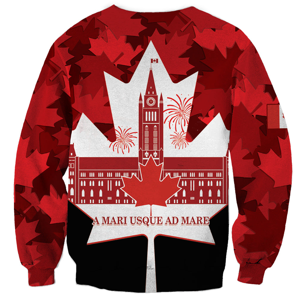 Red crewneck sweatshirt with large white maple-leaf star and fireworks graphic