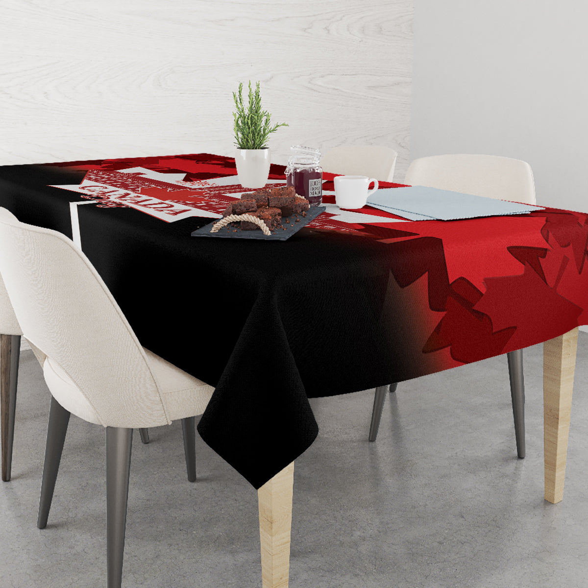 Red and black Canada Day tablecloth with maple leaf shapes on dining table