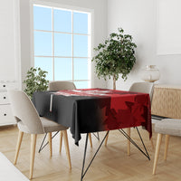 Red and black Canada Day tablecloth over dining table with maple leaf pattern