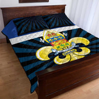 Blue, black, and white quilt bed set with Quebec crest and fleur-de-lis, shown on bed with pillows