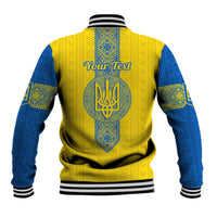 Baseball jacket back view: yellow with blue folk pattern, centered trident graphic, rib hem