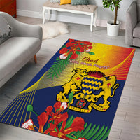 Colorful blue Chad emblem area rug with flowers, leaves, and striped rays