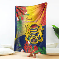 Blue blanket featuring lion crest and tropical flowers with red-yellow trim
