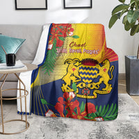 Blue Chad-themed blanket draped on chair, lion emblem and tropical floral print