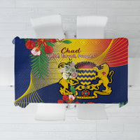 Blue tablecloth with colorful tropical and emblem print, draped over square table
