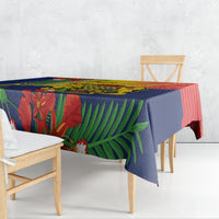 Blue patterned tablecloth with tropical leaves, hanging over the table edge