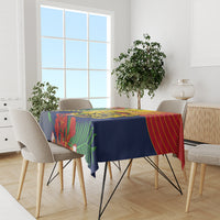 Blue tablecloth with colorful tropical print on dining table with four chairs