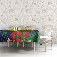 Blue tablecloth with tropical leaf artwork, draped over rectangular dining table