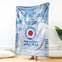 Blue Japan football blanket with large circular emblem and city street pattern, draped