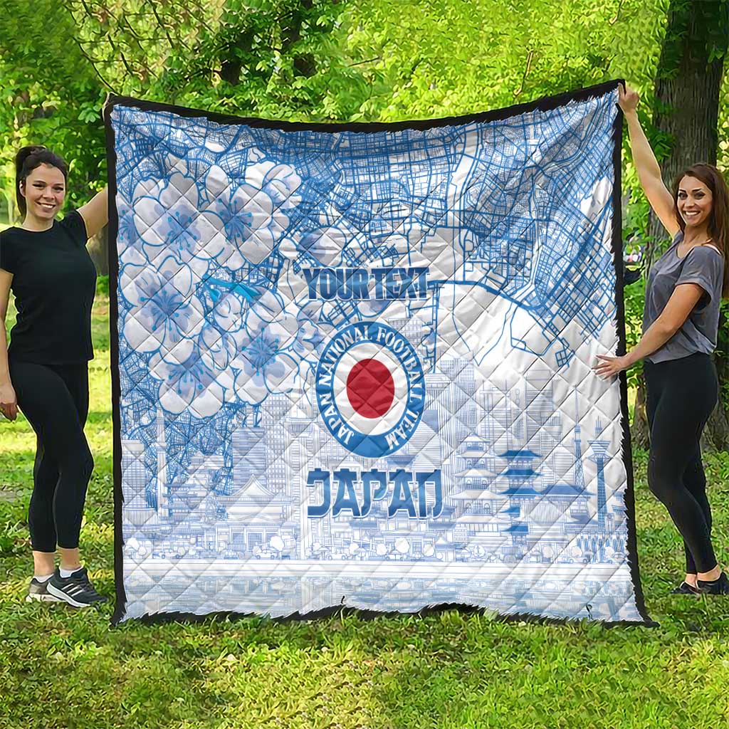 Blue and white quilt with Japan football emblem, city map lines, and cherry blossom flowers