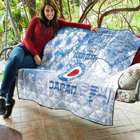 Blue and white quilt draped over seating with Japan football emblem and cherry blossom motif
