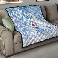 Blue and white quilt folded on a sofa with Japan football logo and city map pattern