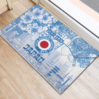 Blue rubber doormat with horizontal view of floral, city map lines, and Japan crest