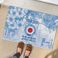 Blue rubber doormat with floral and city map print, Japan crest and JAPAN text