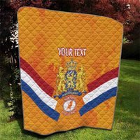 Orange Netherlands rugby quilt with diamond stitching, diagonal stripes, and crest