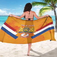 Orange custom rugby sarong held wide, center text and lion crest on striped design