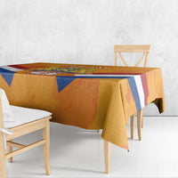 Orange tablecloth draped over dining table edge with blue diagonal stripes and red accents
