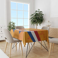 Orange tablecloth on dining table with Netherlands banner design in blue, white, and red