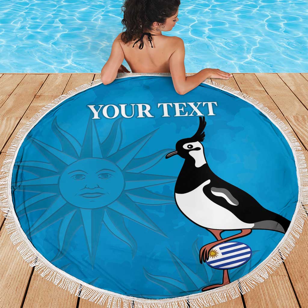 Blue circular beach blanket with white fringe, bird graphic and “YOUR TEXT” in center