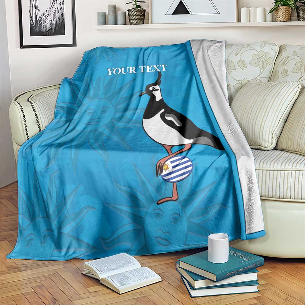 Blue custom rugby blanket draped on couch, penguin and 'YOUR TEXT' design