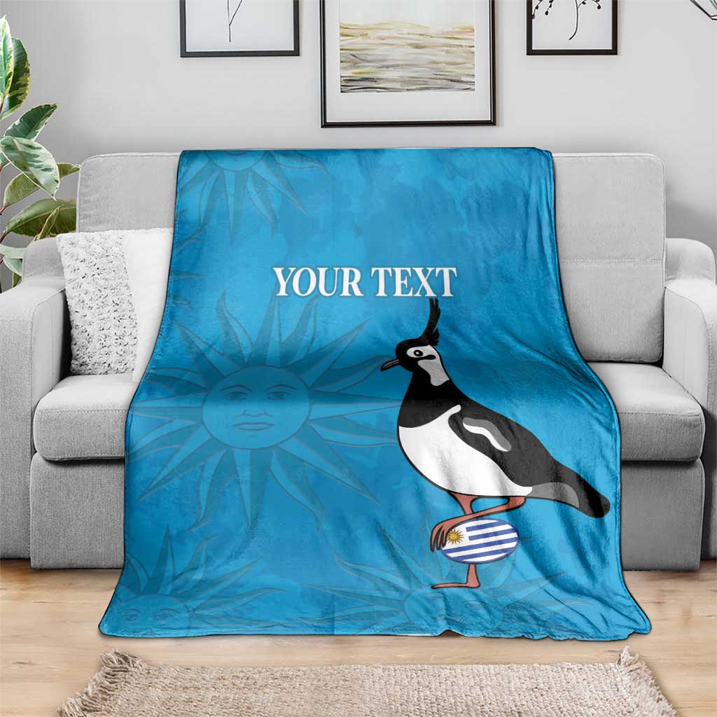 Blue custom rugby blanket on sofa with penguin holding striped ball and 'YOUR TEXT'