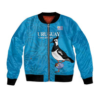 Unisex blue bomber jacket with black ribbed trim, zip front, Uruguay flag & penguin art