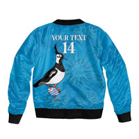 Unisex blue bomber jacket with black ribbed trim, full-zip front, penguin graphic