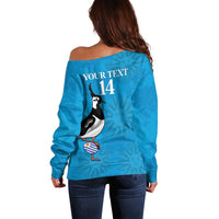Blue off-shoulder rugby sweater with back penguin graphic and number 14