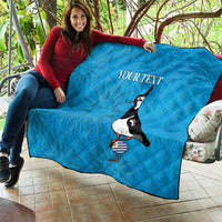 Blue quilt draped over sofa with penguin holding striped ball and 'Your text'.