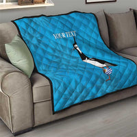 Blue quilt on living-room sofa with penguin graphic and 'Your text'.
