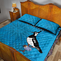 Blue quilt bed set with quilted cover, two pillows, penguin graphic, 'YOUR TEXT'.