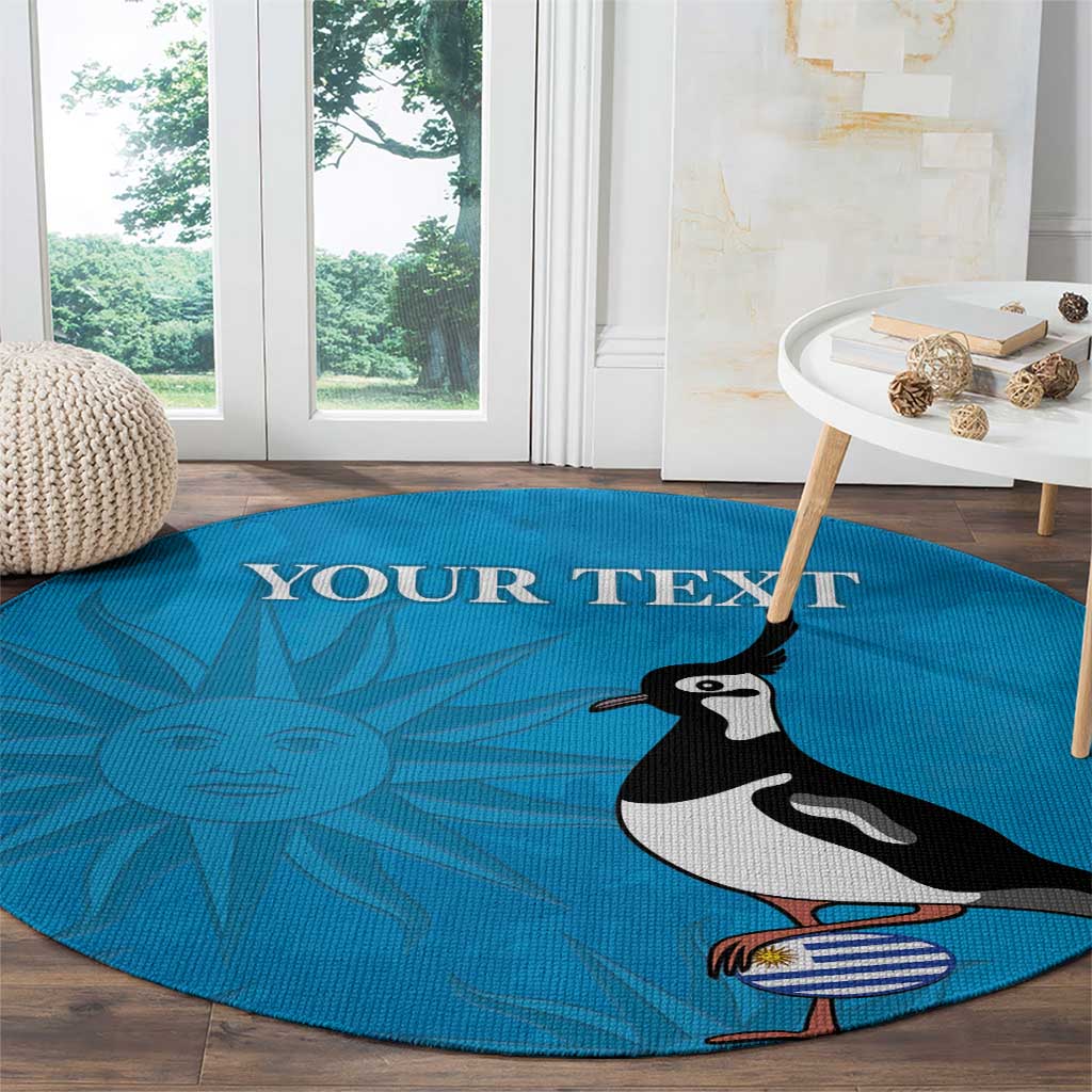 Blue round carpet featuring 'YOUR TEXT', sun motif, and lapwing holding Uruguay flag