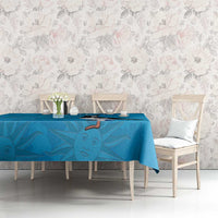 Blue tablecloth with penguin and sunburst pattern over a long dining table