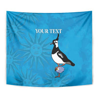 Blue tapestry close view with penguin graphic and sunburst pattern
