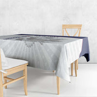 White tablecloth with blue border stripe and eagle motif across the tabletop