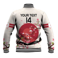 White rugby jacket back with large red cherry blossom circle, black ribbed hem and cuffs
