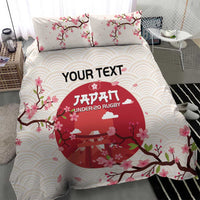 White duvet cover and two pillowcases with pink flowers, wave pattern, and red rugby logo