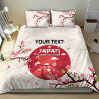 White duvet cover with two matching pillowcases featuring pink cherry blossoms and red emblem
