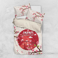 White duvet cover with two pillowcases; pink blossoms over red circular rugby emblem
