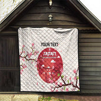 White quilt blanket on wall display with red Japan Under-20 rugby emblem and cherry blossom pattern.
