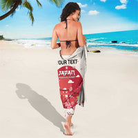 Back view of white rugby sarong with red emblem, cherry blossoms, and wave pattern