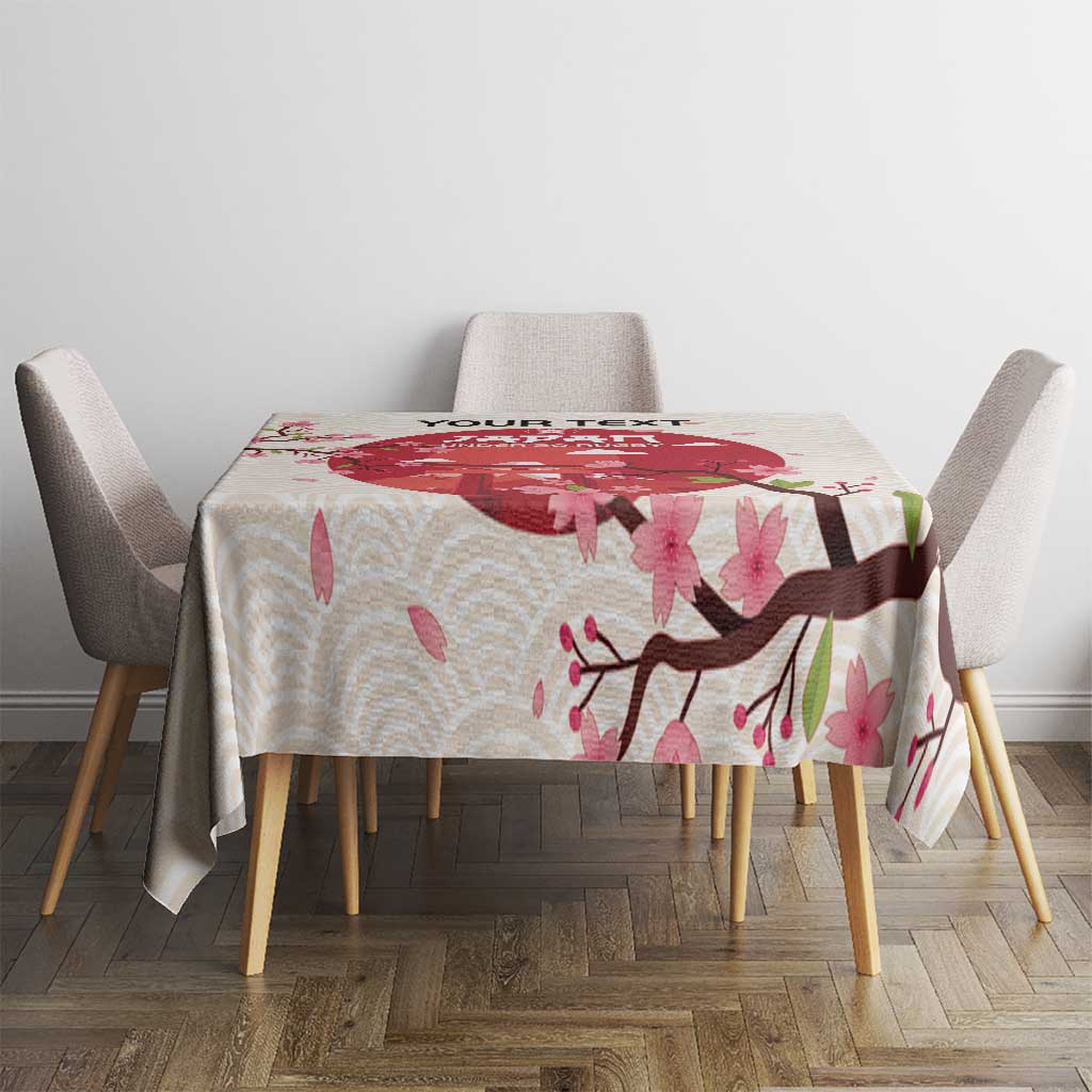 White tablecloth with pink cherry blossoms and branch graphic on a dining table